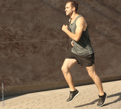 Sporty young man running ou...