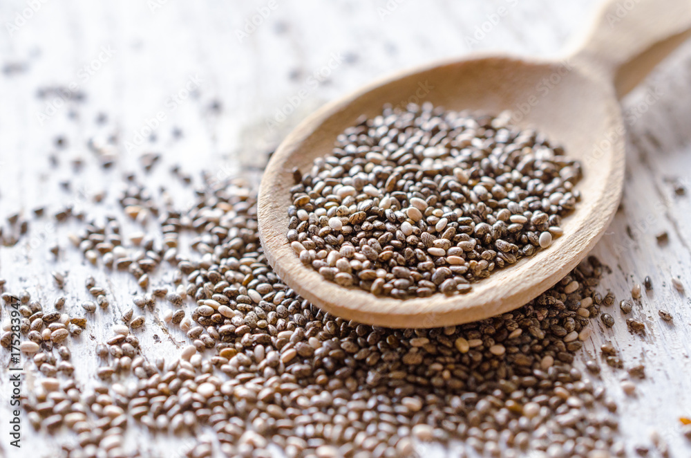 Chia seeds in a wooden spoon. Macro. Chia seeds in a wooden spoon. Macro.