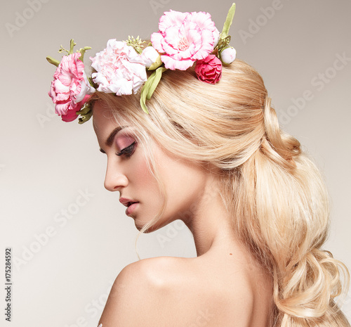 Beautiful woman portrait with long blonde hair and flowers on head. Tender bride. 