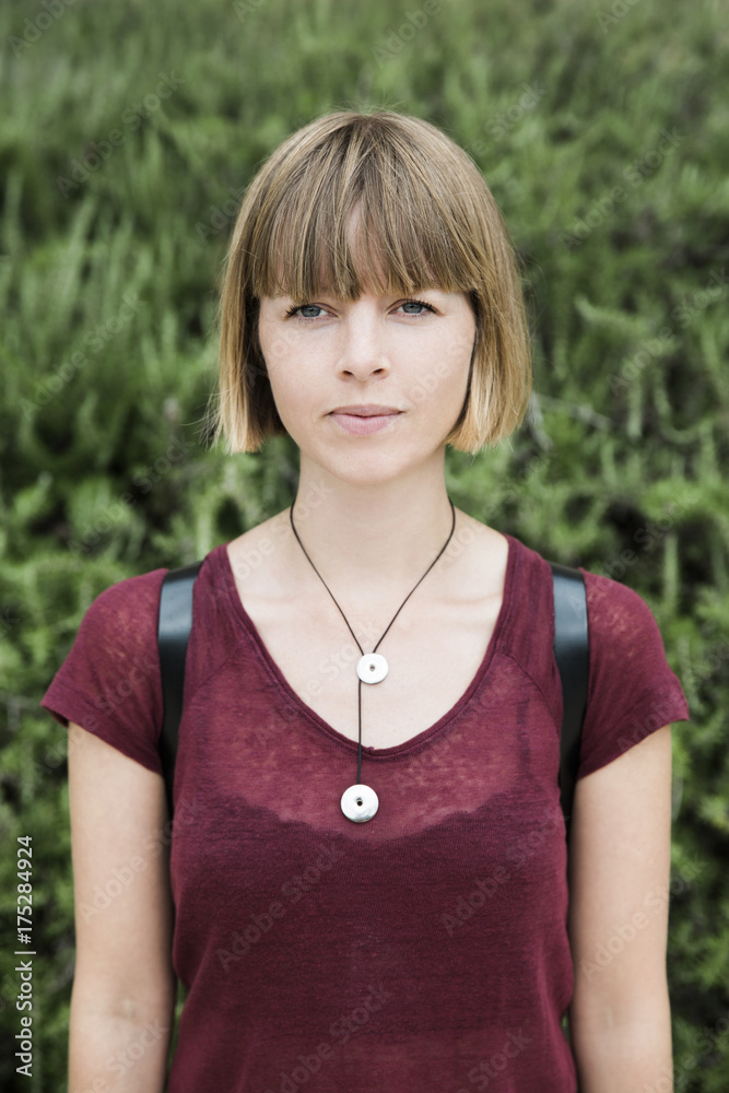 Portrait of a young blond woman outdoors looking at camera Portrait of a young blond woman outdoors looking at camera