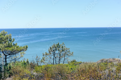 Peaceful coastal sunshine beach with hillside over ocean view natural background. Sunny dream holiday destination