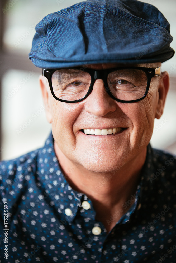 Senior stylish man portrait wearing a beret and glasses Senior stylish man portrait wearing a beret and glasses