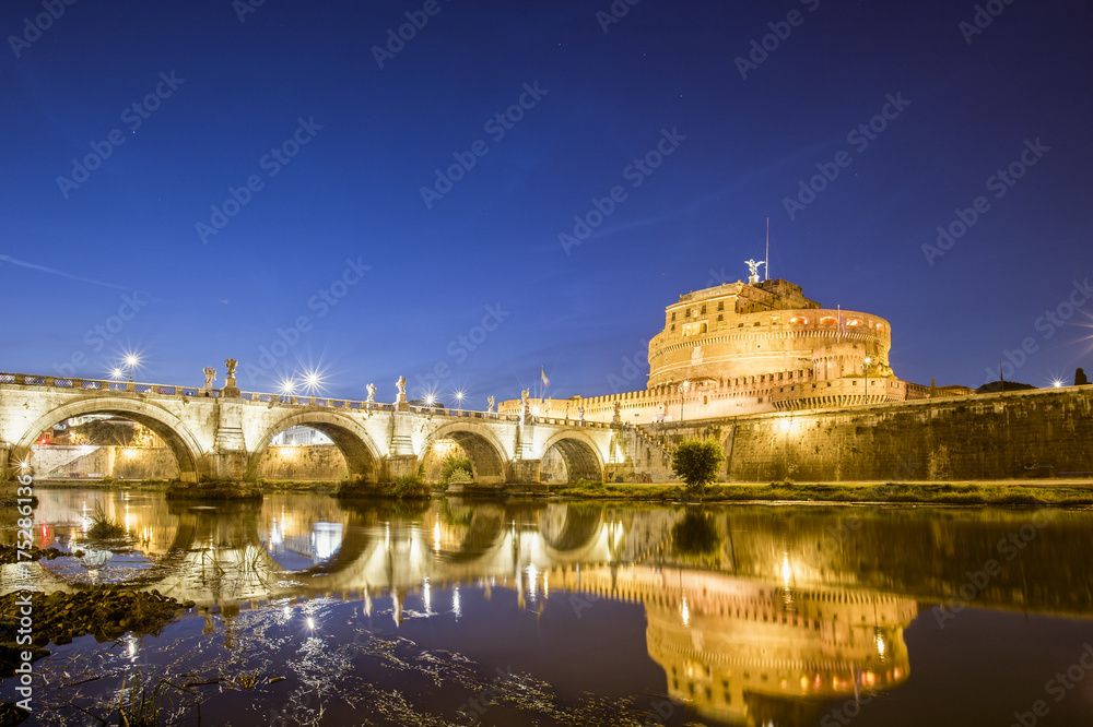 ROME, ITALY 28 SEPTEMBER 2017, The Mausoleum of Hadrian, usually known as Castel Sant'Angelo and the Sant'Angelo bridge illuminated by night. Photo taken on the banks of the Tiber River.