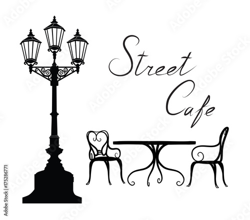 Street cafe - table, chairs, streetlight and lettering City life