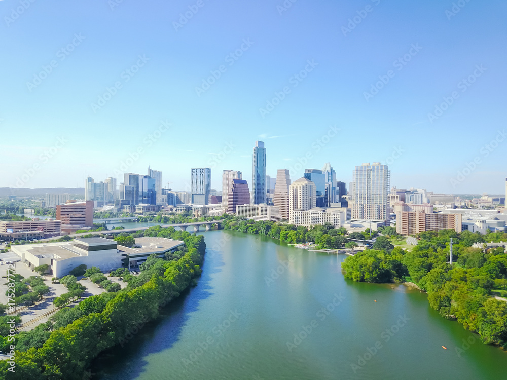 Aerial view green Austin state capital of Texas, USA with downtown skyscraper from Lady Bird Lake. People paddle kayak along Colorado River during sunny summer day. Travel and architecture background