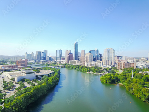 Aerial view green Austin state capital of Texas, USA with downtown skyscraper from Lady Bird Lake. People paddle kayak along Colorado River during sunny summer day. Travel and architecture background © trongnguyen