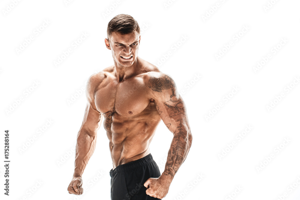 Fototapeta premium Tattooed muscular super-high level handsome man posing in studio isolated on white background