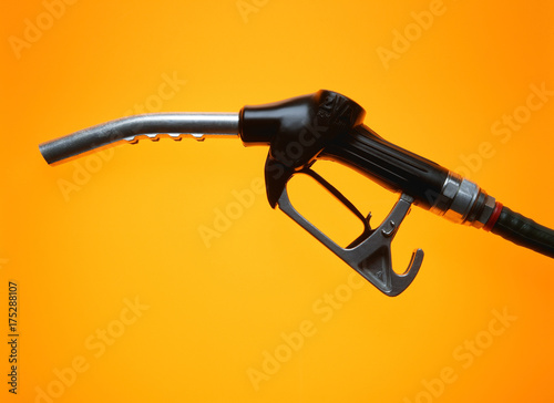 Petrol pump on yellow background