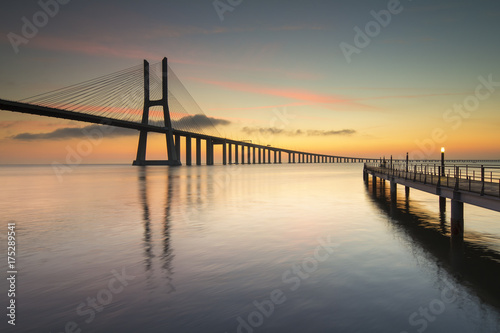 asco da Gama Bridge and pier over Tagus River in Lisbon, Portugal, just before sunrise