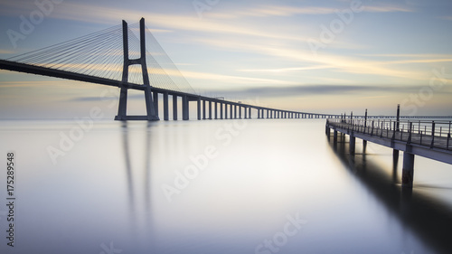 asco da Gama Bridge and pier over Tagus River in Lisbon, Portugal, just before sunrise