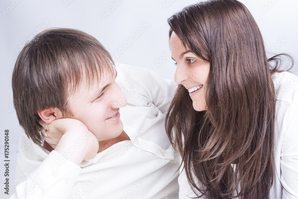 Family Relationships Concepts. Young Caucasian Family Communicating Together on Floor. Smiling and Embracing Each Other Family Relationships Concepts. Young Caucasian Family Communicating Together on Floor. Smiling and Embracing Each Other