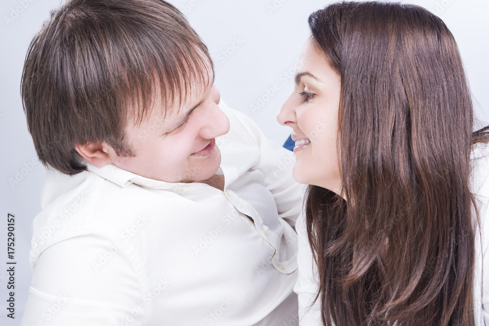 Family Relationships Concepts. Young Caucasian Family Communicating Together on Floor. Smiling and Embracing Each Other. Family Relationships Concepts. Young Caucasian Family Communicating Together on Floor. Smiling and Embracing Each Other.