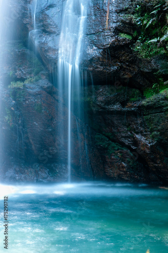 Waterfall in summer time. Long exposure on translucent turqouise water.