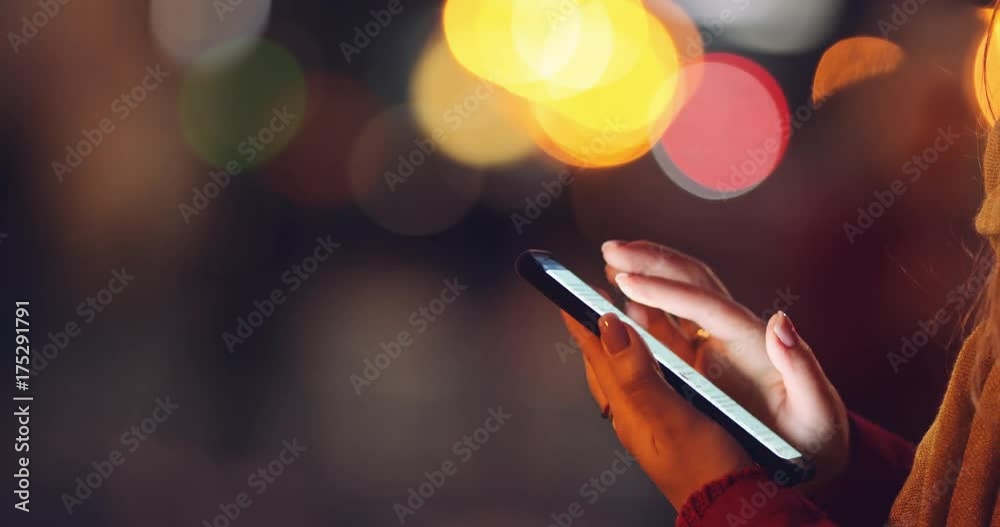 Woman Hands Using Smartphone at Dusk in the City, Close Up. 4K SLOW MOTION. Millennial Girl reading on cell phone, using app social media, texting. Blurred Night Street lights background.