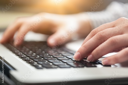 Woman working on laptop.