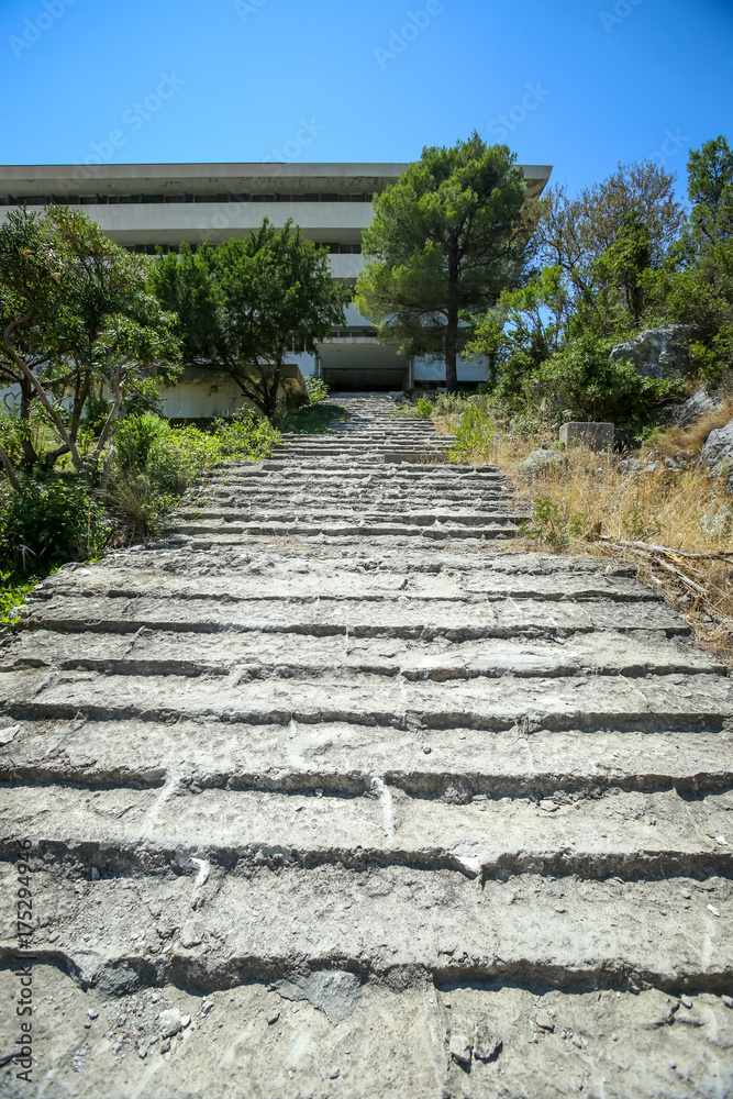Stone steps leading to an old abandoned hotel. Stone steps leading to an old abandoned hotel.
