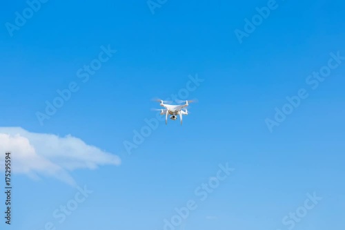 Drone flying into the blue sky
