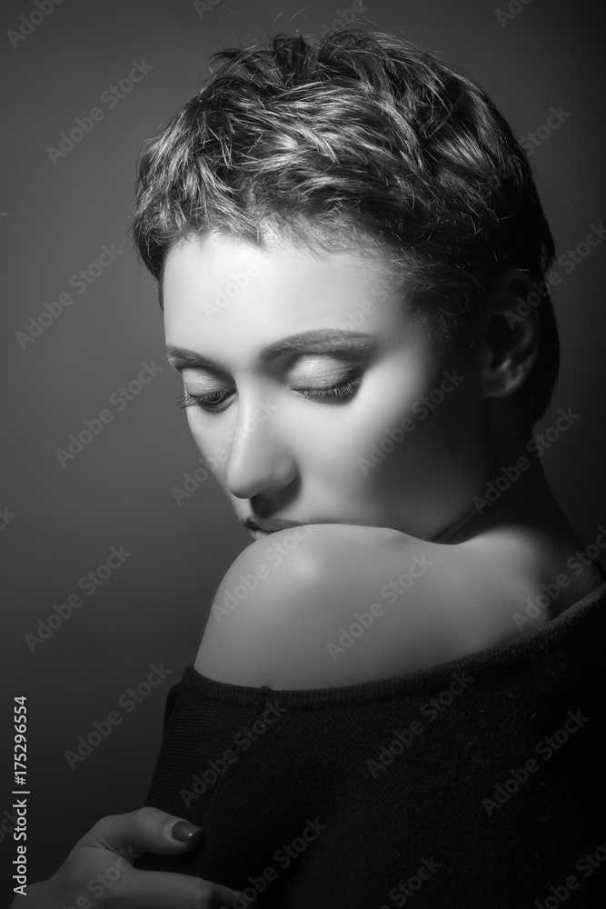 portrait of beautiful sensual woman looking at camera on dark background 
