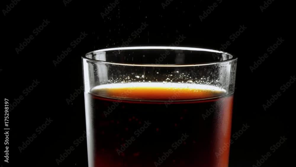 Pouring refreshing ice cold Cola in a glass Pouring refreshing ice cold Cola in a glass