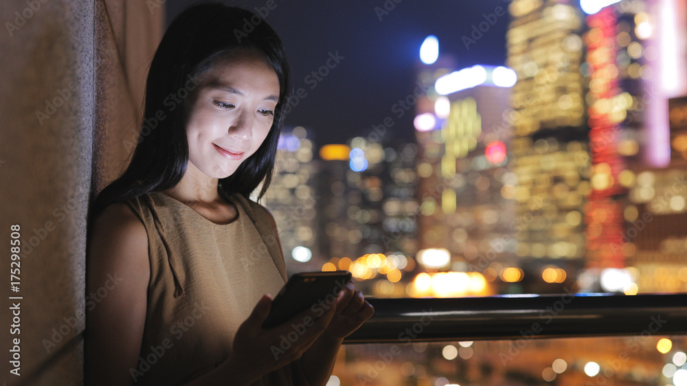 Woman working on cellphone in Hong Kong Woman working on cellphone in Hong Kong