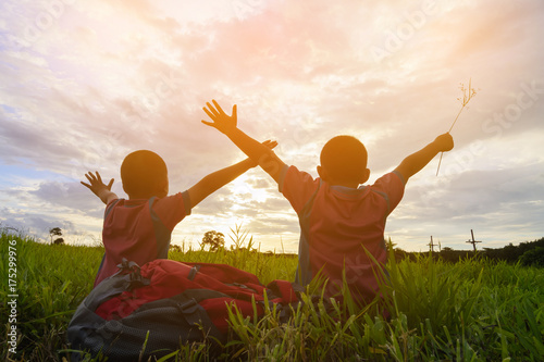 Brother and brothers are happy with sunset on the mountain view in chaingmai Thailand.