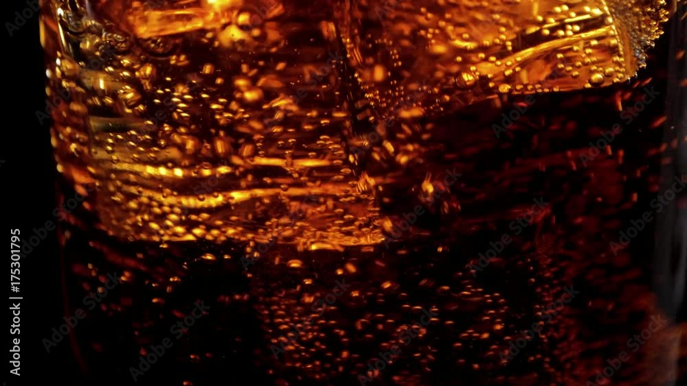 Amazing shot of ice cubes in Cola - perfect background of refreshing soda Amazing shot of ice cubes in Cola - perfect background of refreshing soda