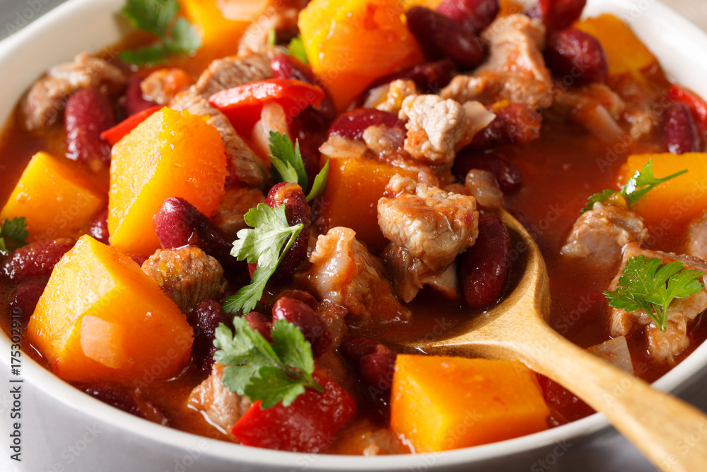 Chili pumpkin with beef and vegetables in tomato sauce macro. horizontal