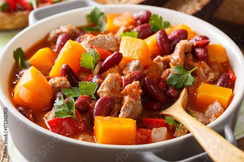 Spicy pumpkin chili soup with beef, tomatoes and red beans macro. horizontal