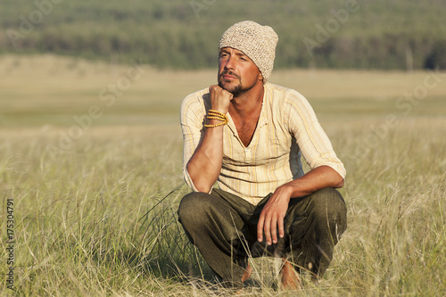 Fotografija young man in ethnic clothes, reverie