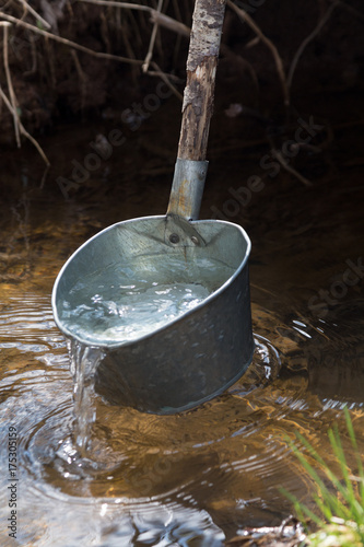 Clear water in a laddle from river