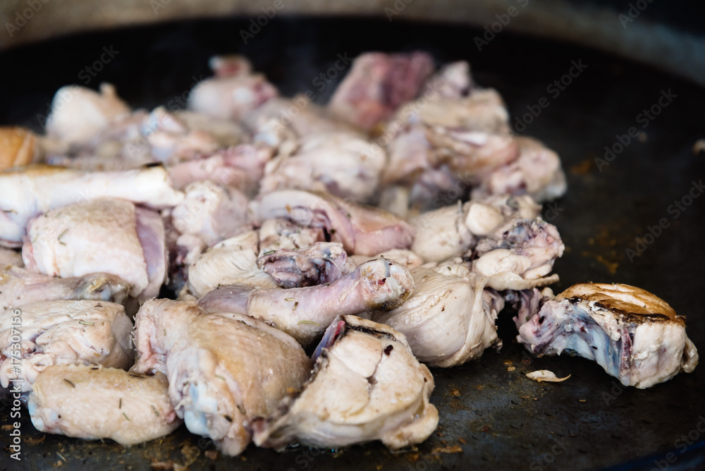 Fried chicken legs and wings. Preparation of chicken paella, a S Fried chicken legs and wings. Preparation of chicken paella, a S