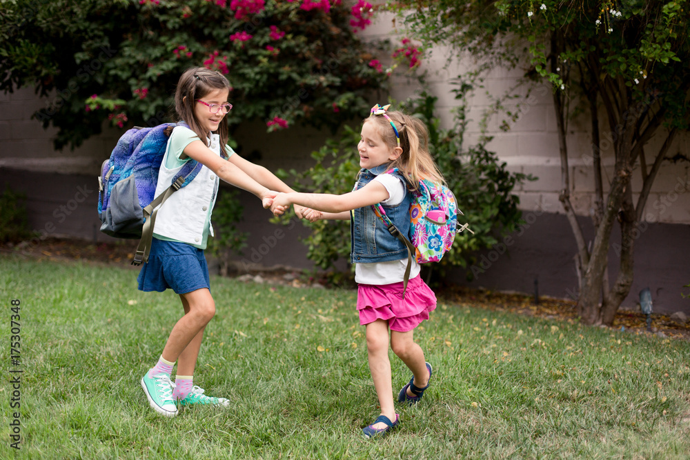 Two girls are playing excitedly and anxiously before their first day of school. Two girls are playing excitedly and anxiously before their first day of school.