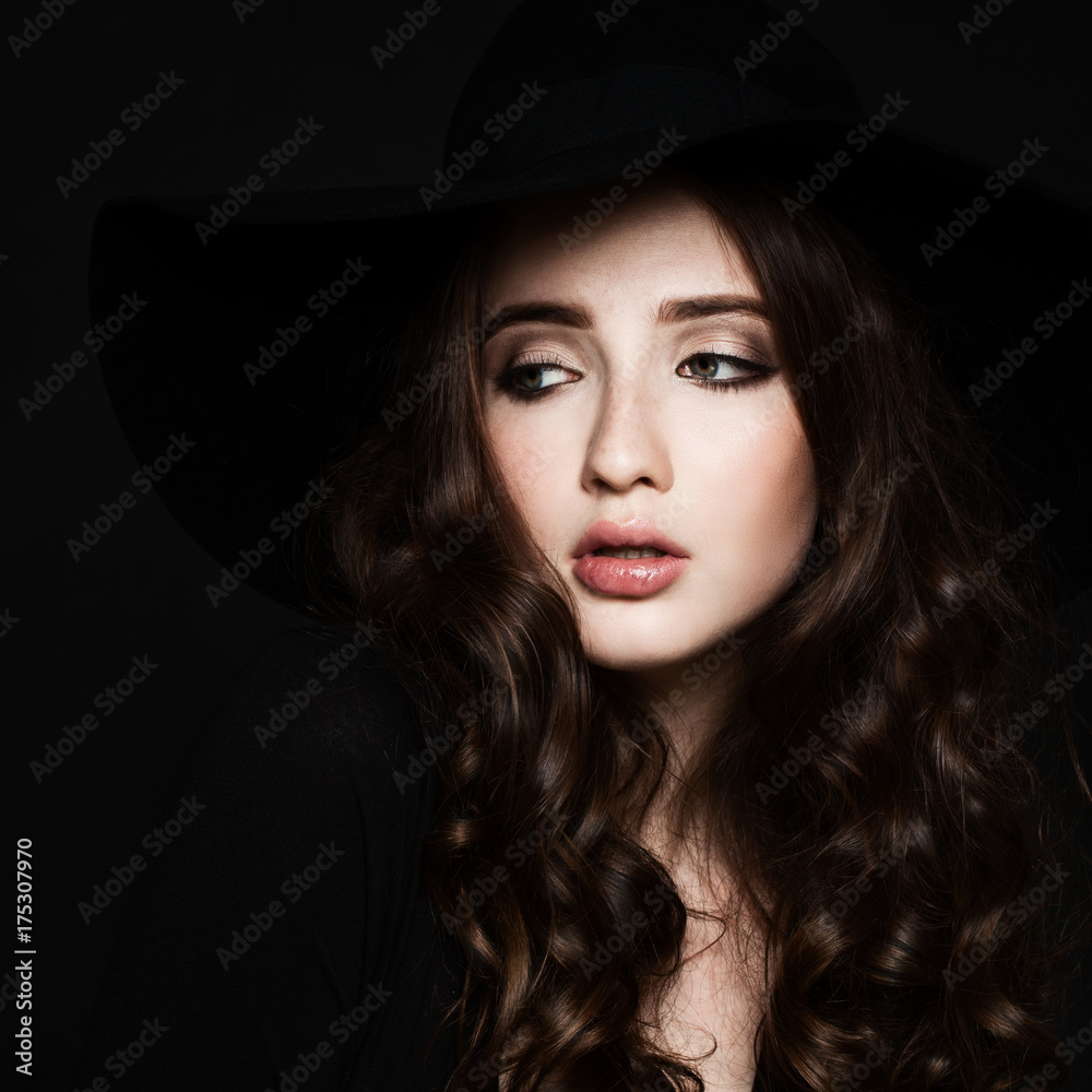 Young Woman Fashion Model with Makeup and Curly Hair on Black Background, Retro Style Portrait Young Woman Fashion Model with Makeup and Curly Hair on Black Background, Retro Style Portrait