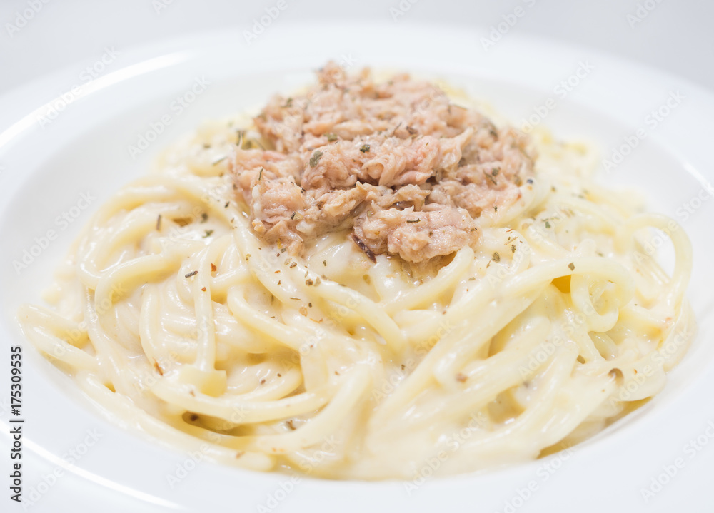 Pasta Carbonara with tuna on a white plate
