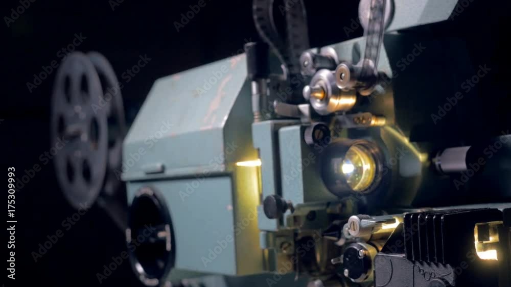Old movie projector working in dark cinema hall. 4K. Old movie projector working in dark cinema hall. 4K.