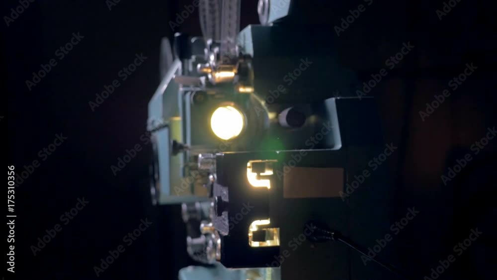 Film projector working in dark. Dolly shot. Film projector working in dark. Dolly shot.