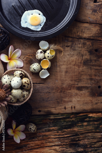studio shot of quail eggs on a vintage wooden background.