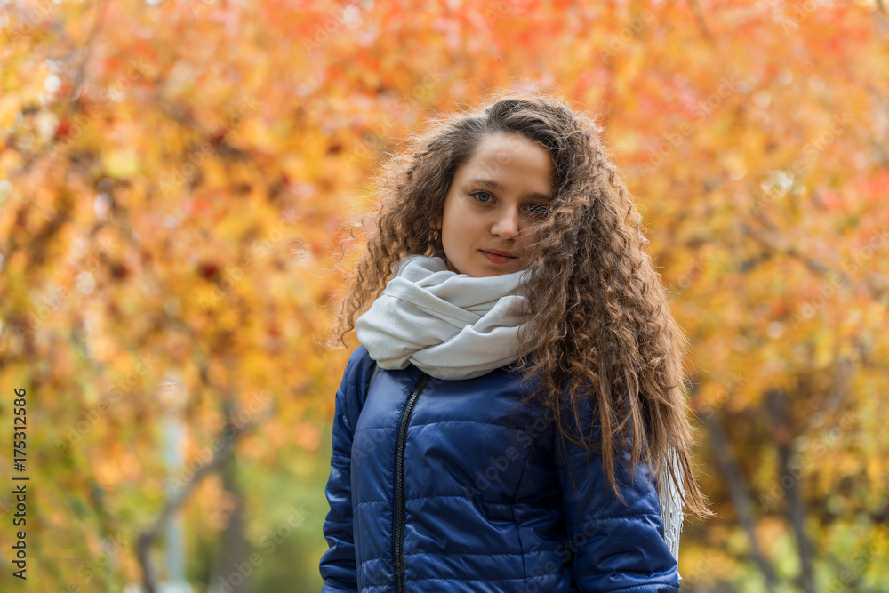 Girl with curly hair against a background of autumn foliage Girl with curly hair against a background of autumn foliage