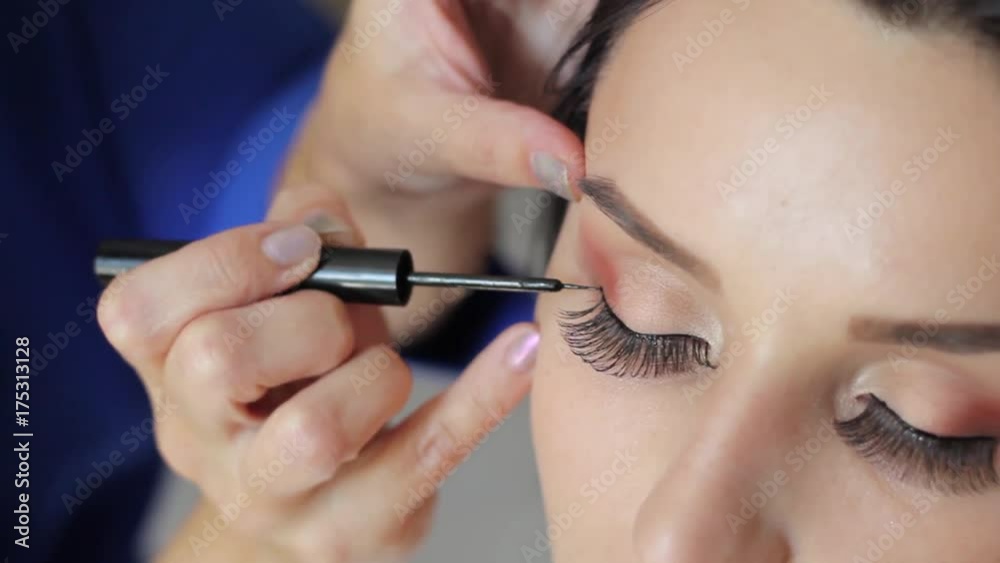make up artist doing professional make up of young woman make up artist doing professional make up of young woman