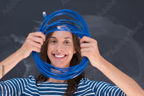 woman holding a internet cable in front of chalk drawing board