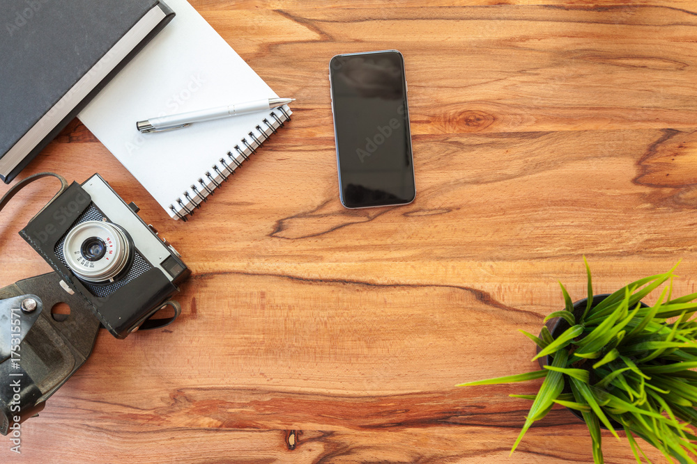 Sheets of paper, retro camera and smartphone on table. Sheets of paper, retro camera and smartphone on table.