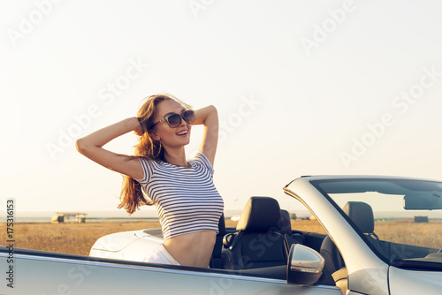  attractive young woman near a convertible car © fotofabrika