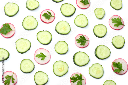 mix of sliced cucumber with sliced radish isolated on a white background top view