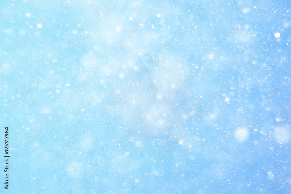 Snowfall texture of snowflakes on blurred background
