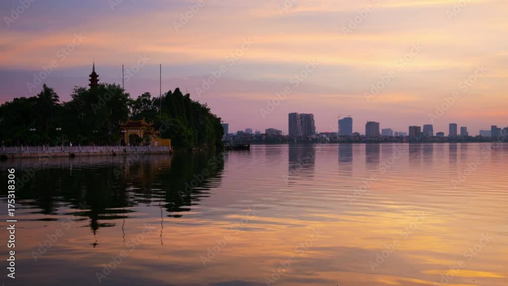 Hanoi, Vietnam. Tran Quoc Pagoda the oldest Buddhist temple in Hanoi, Vietnam. Located on a small island in West Lake. Time-lapse at sunset. Getting dark Hanoi, Vietnam. Tran Quoc Pagoda the oldest Buddhist temple in Hanoi, Vietnam. Located on a small island in West Lake. Time-lapse at sunset. Getting dark