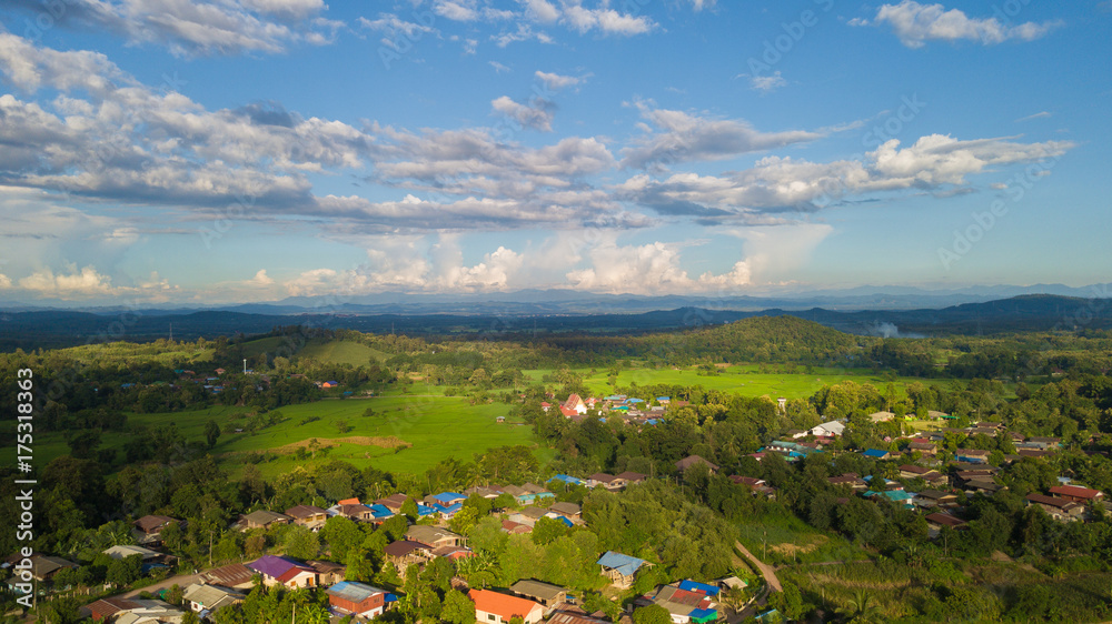 Top view of village houses and  rice fields in Nan, Thailand.