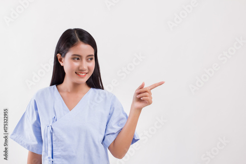 woman patient pointing finger up to blank space