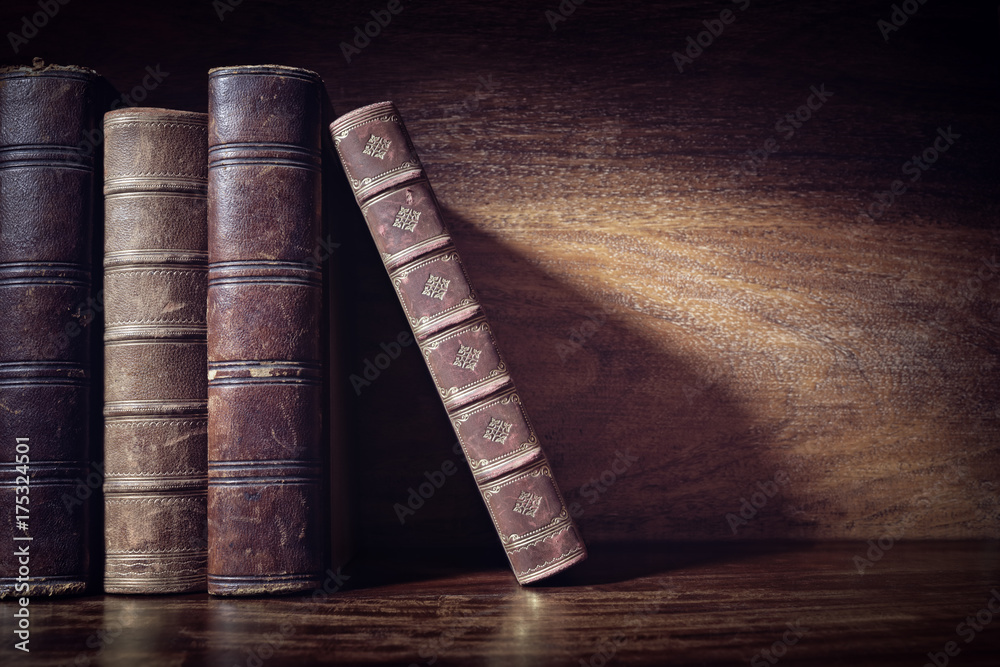 Fototapeta premium Old books on a library shelf background