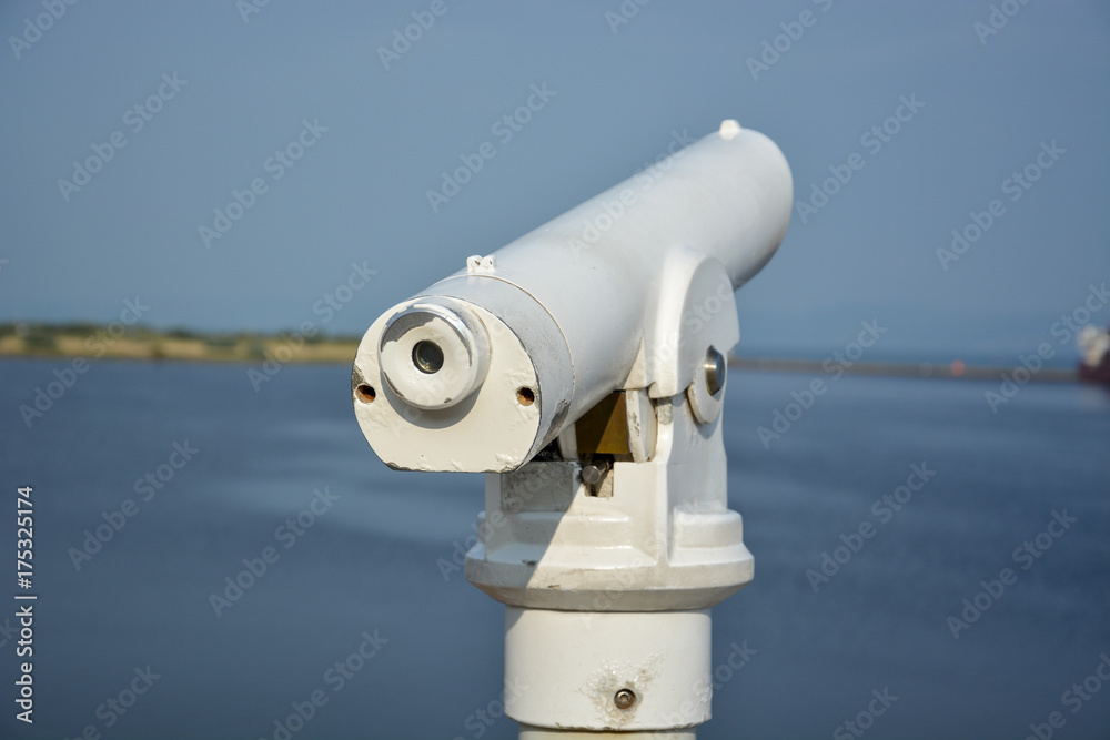 A white telescope on a ship in the sun