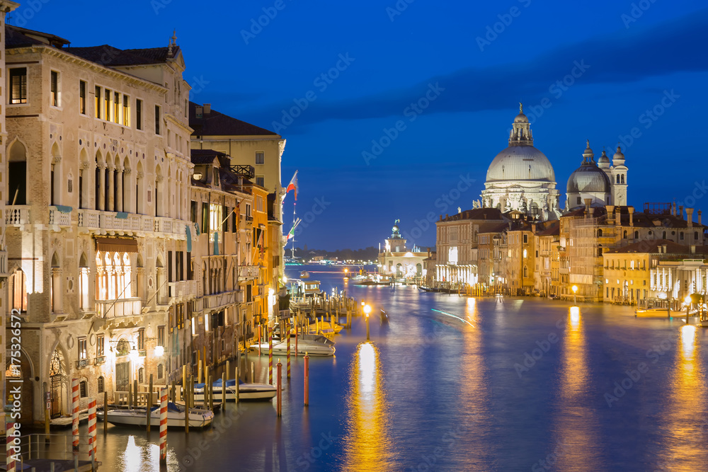 Basilica Santa Maria della Salute, Punta della Dogona and Grand Canal at blue hour sunset in Venice, Italy with reflections.
